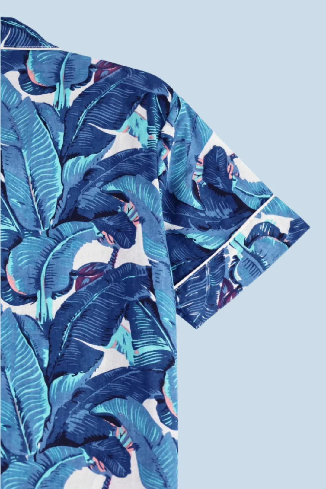 Flat lay of N Faria Blue Leaf Luxe PJ shirt with tropical print.