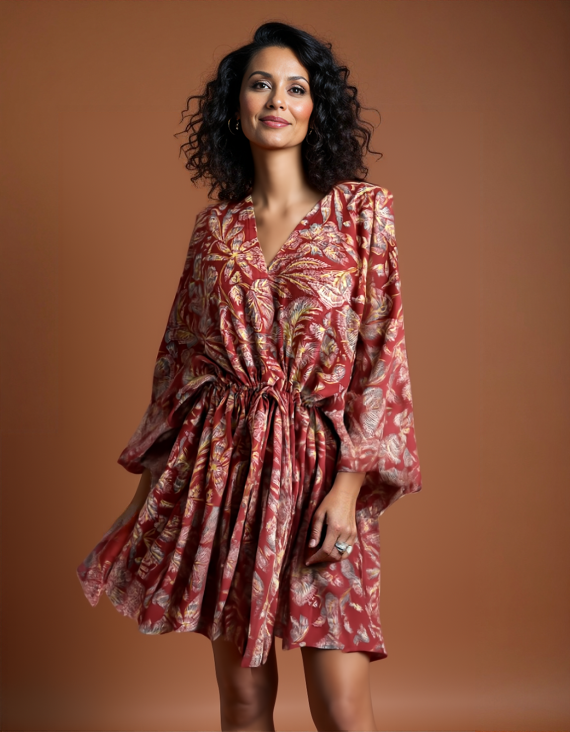 A woman posing confidently wearing The Solace Kaftan by N Faria
